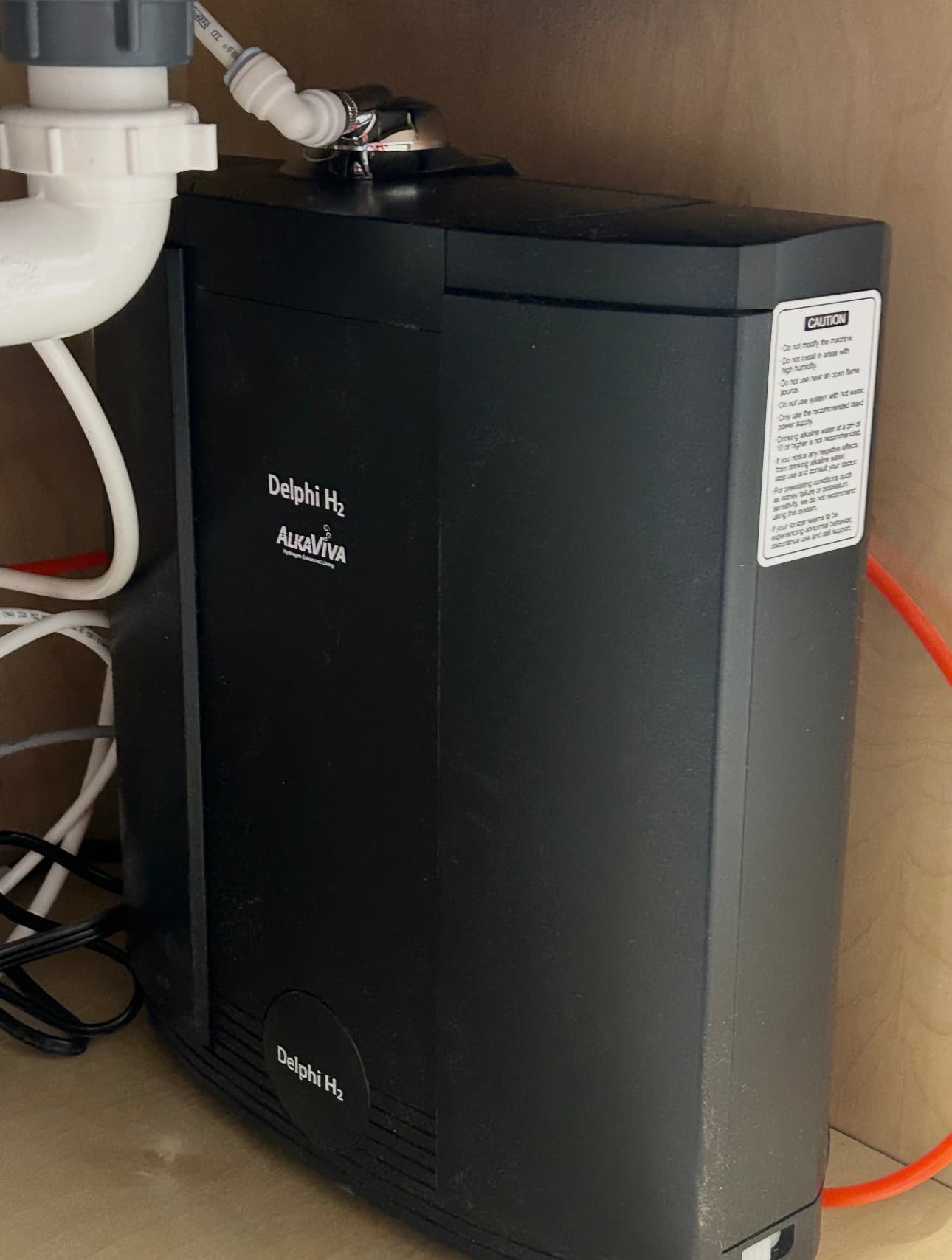 The Delphi H2 by AlkaViva, an under-sink alkaline-hydrogen water ionizer, installed in a customer kitchen cabinet