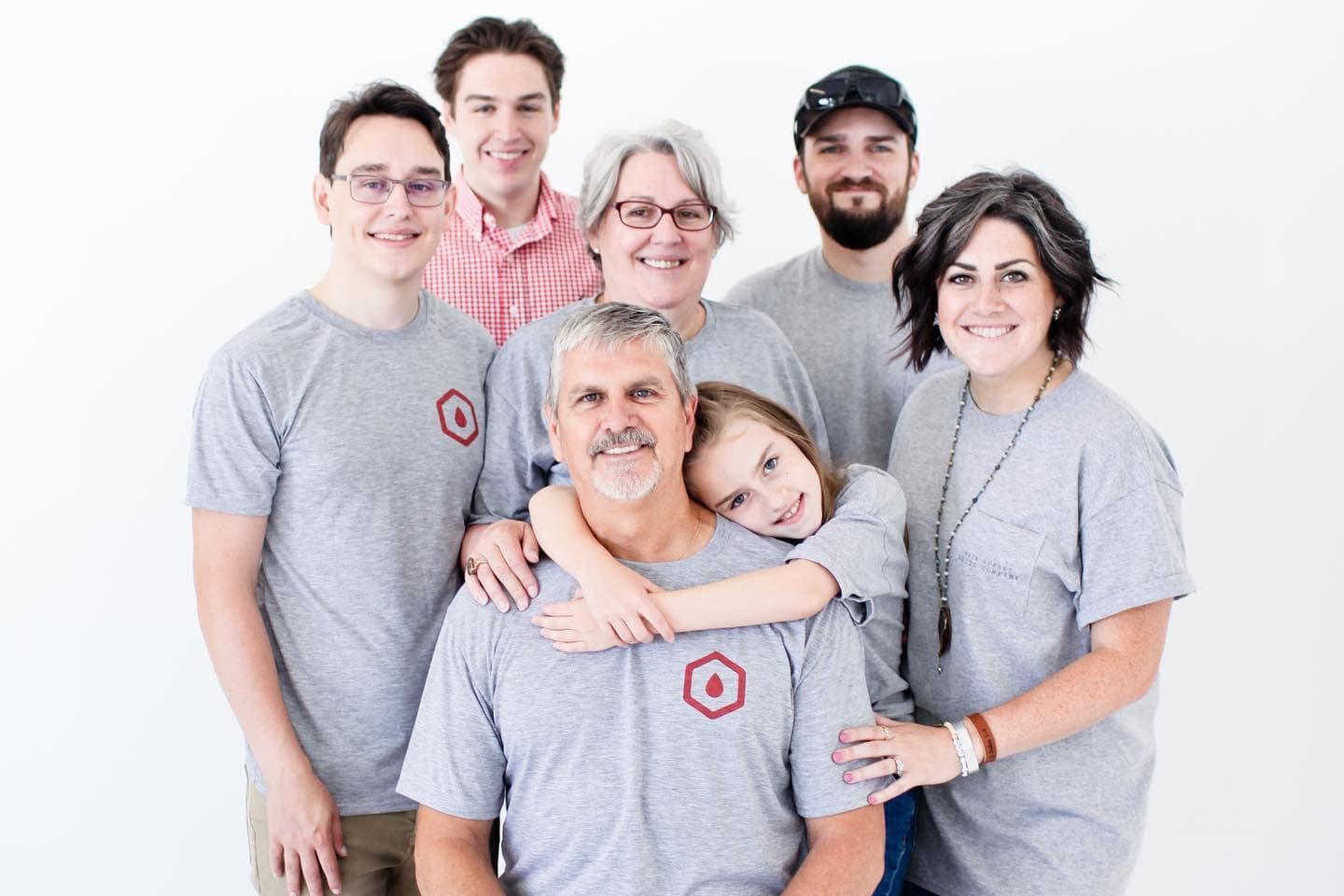 The Hanlon family — Jay, Karen, their children, and granddaughter — in matching Filter Tech shirts